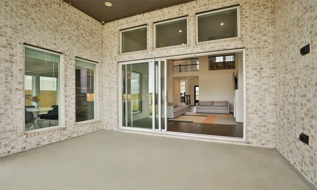 a view of a brick house with a large window