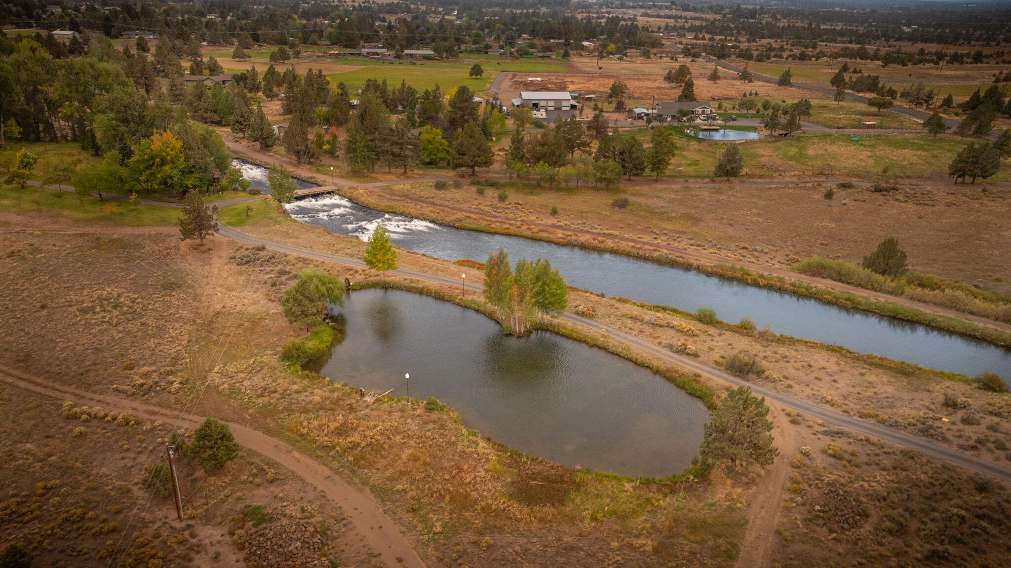 21925 Bear Creek Road Bend, OR 97702 - Photo 103 of 104 Canal and lower pond used for irrigation