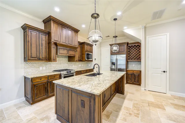a kitchen with stainless steel appliances granite countertop a stove oven and a sink