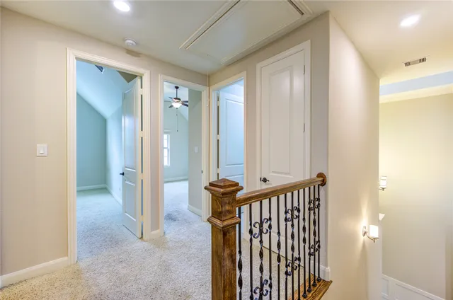 a view of a hallway with entryway door with wooden floor