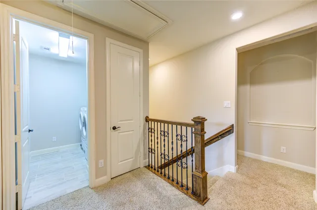 a view of a hallway with entryway door