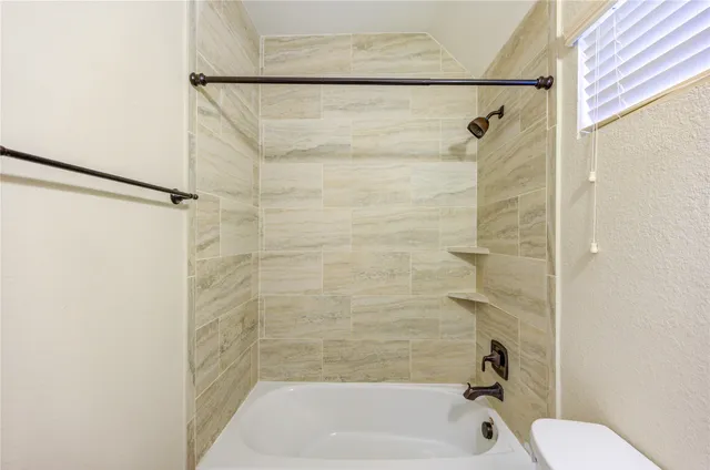 a bathroom with a shower and a toilet