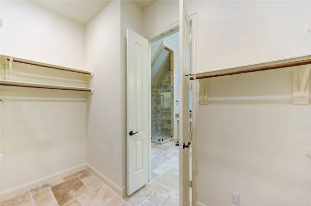 a bathroom with a shower and a glass door