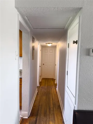 a view of hallway with wooden floor
