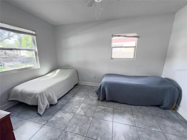 a bed room with a bed and a chair