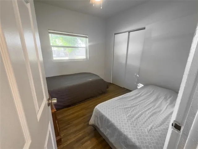 a bedroom with two beds and a window