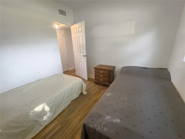 a bedroom with a bed and a night stand