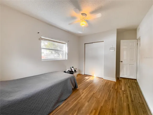 a spacious bedroom with a bed and a chandelier