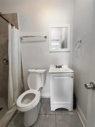 a white toilet sitting next to a bathroom sink