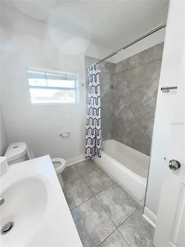 a bathroom with a bathtub and shower