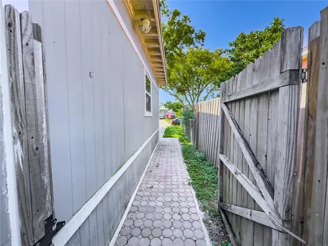 a view of a pathway of a house with wooden floor and a potted plant