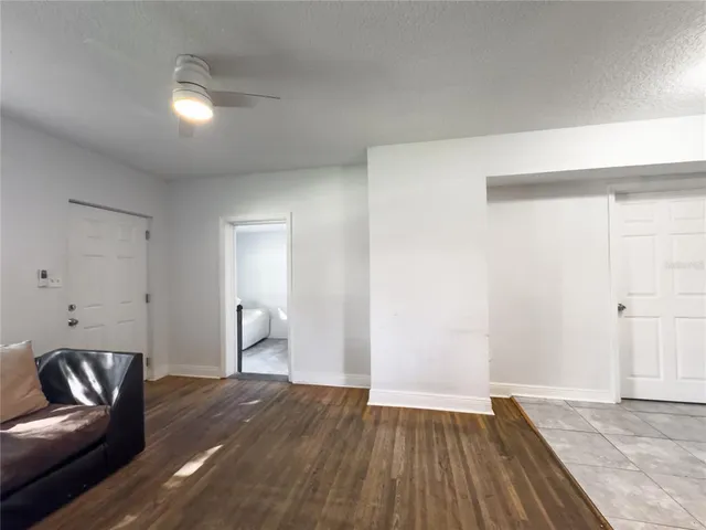 a view of empty room with wooden floor