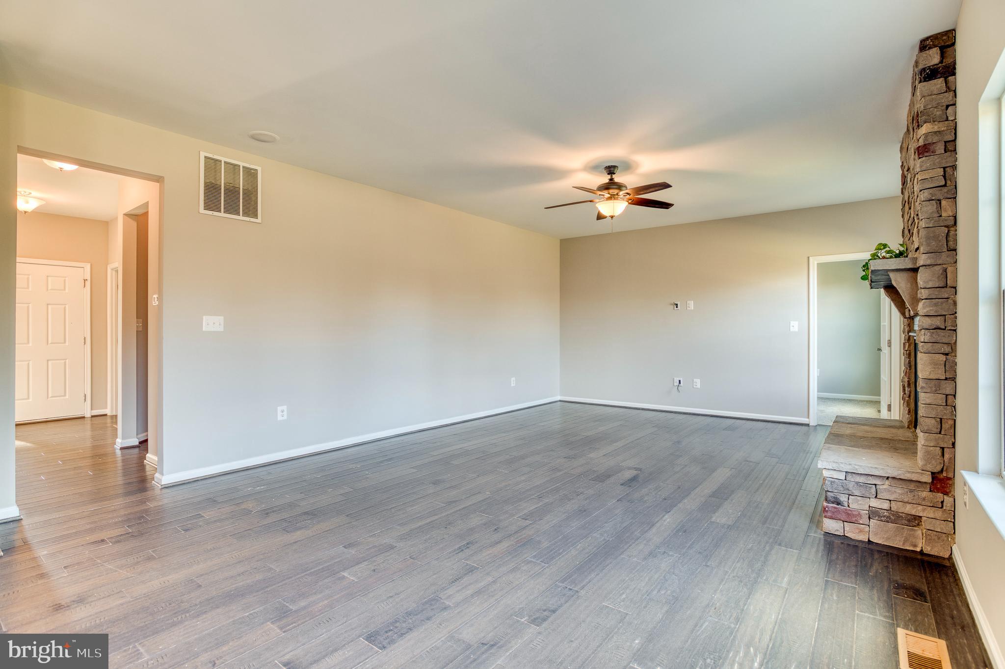 14510 Kingsmill Way Culpeper, VA 22701 - Photo 16 of 64 an empty room with wooden floor and ceiling fan
