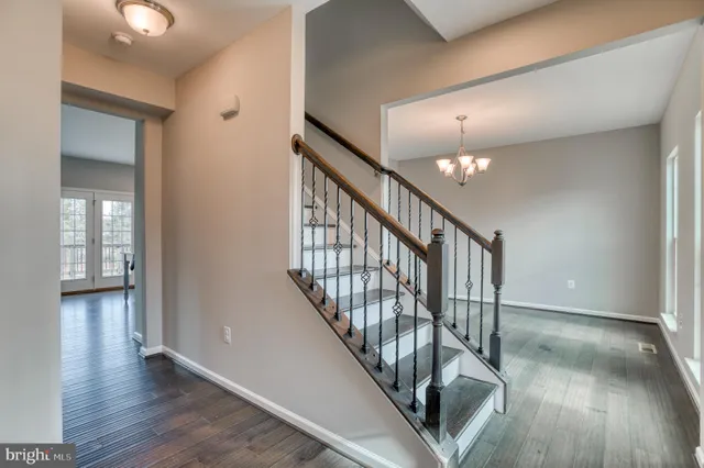 a view of staircase with wooden floor and next to window