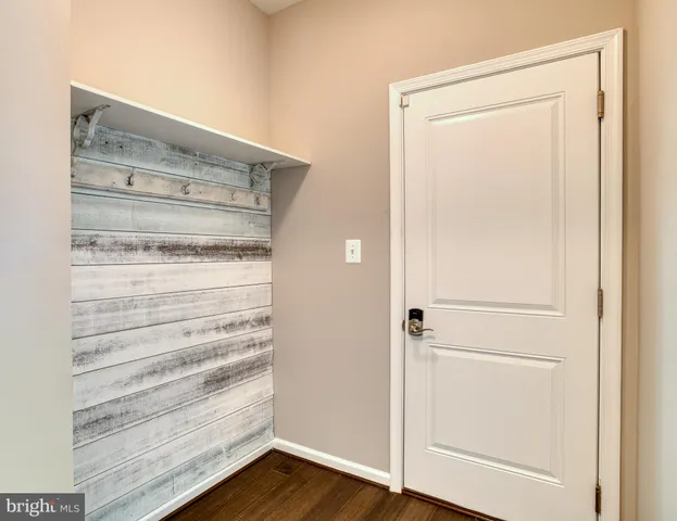 a view of walk in closet with wooden floor