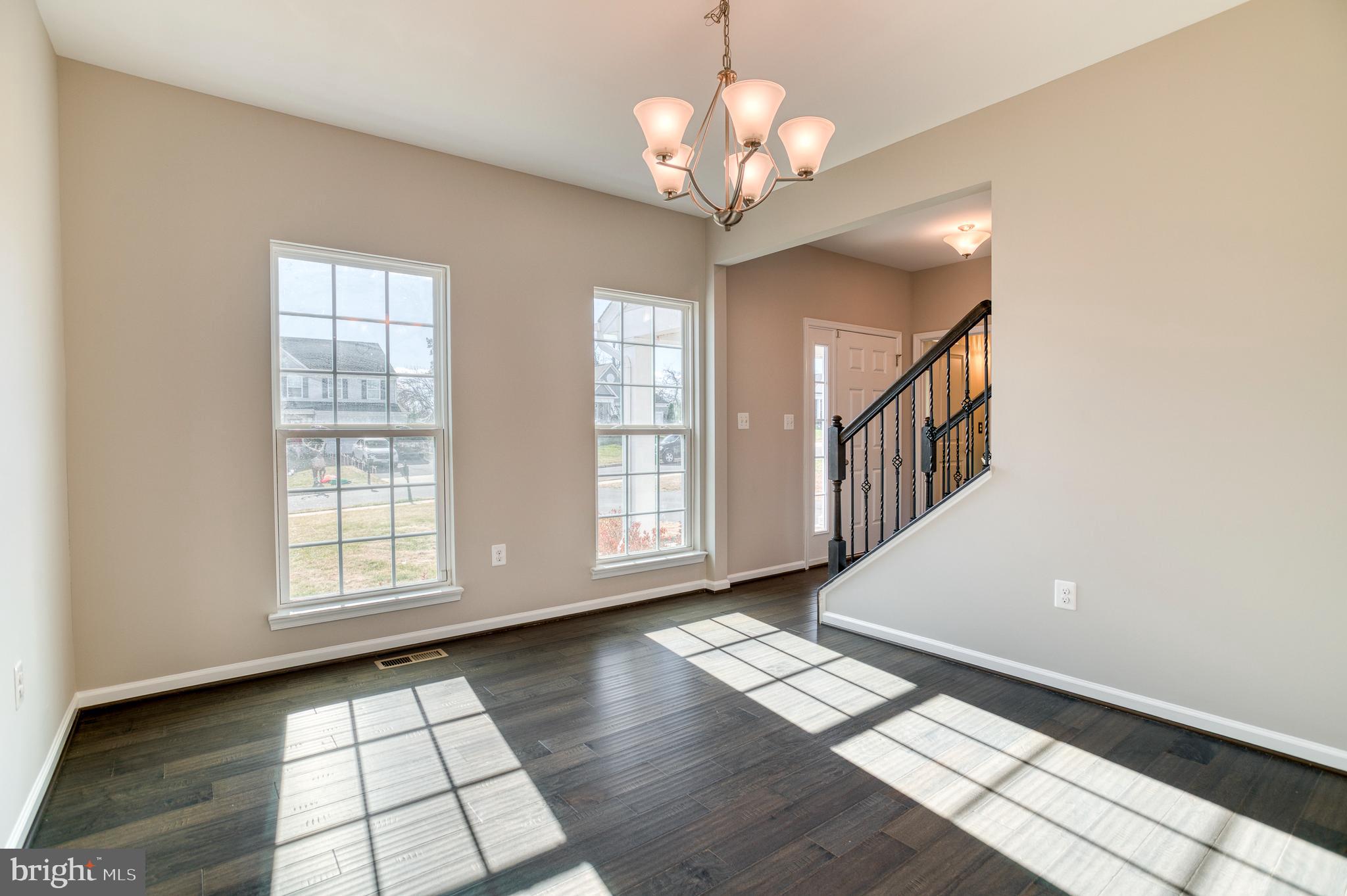 14510 Kingsmill Way Culpeper, VA 22701 - Photo 9 of 64 a view of an empty room with wooden floor and a window