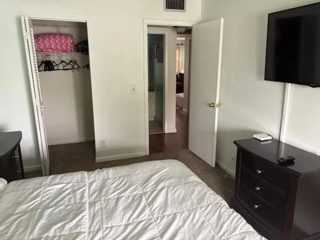 a bedroom with a bed and a flat screen tv