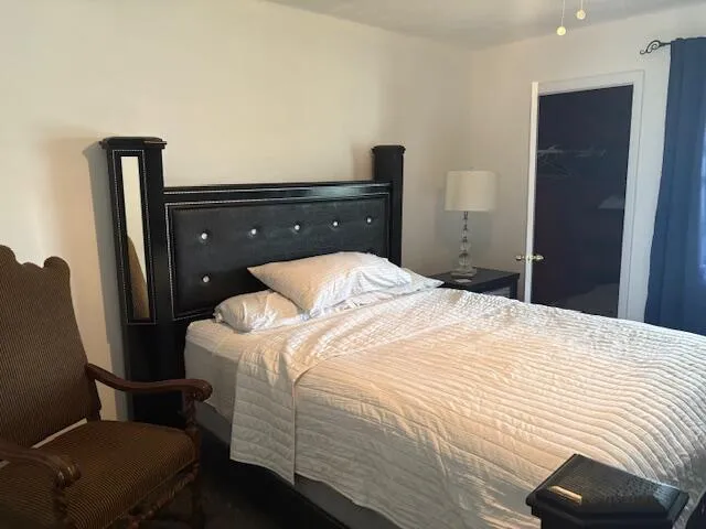 a bedroom with a bed and a mirror