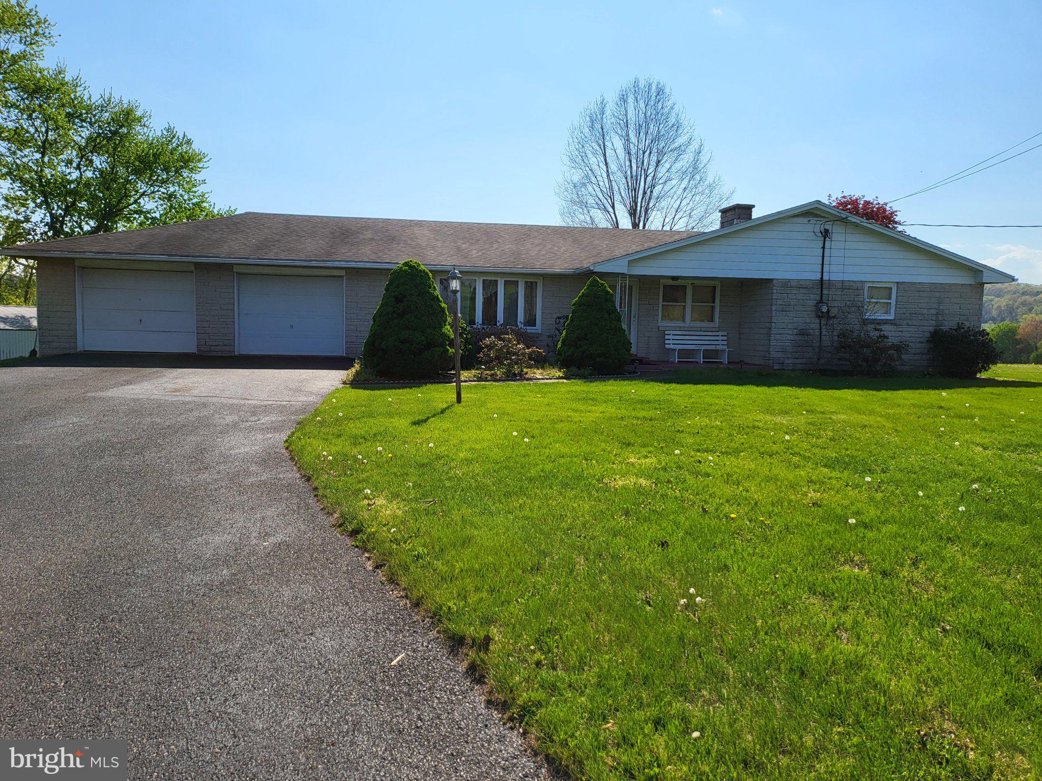 Charming home with lush green lawn.