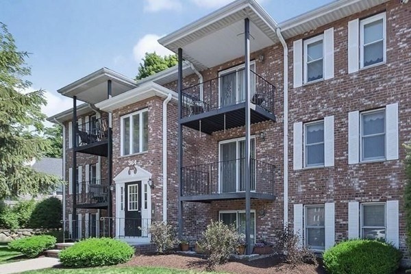 364 Neponset Street, Unit K Canton, MA 02021 - Photo 1 of 15 a front view of a building with a garden and plants