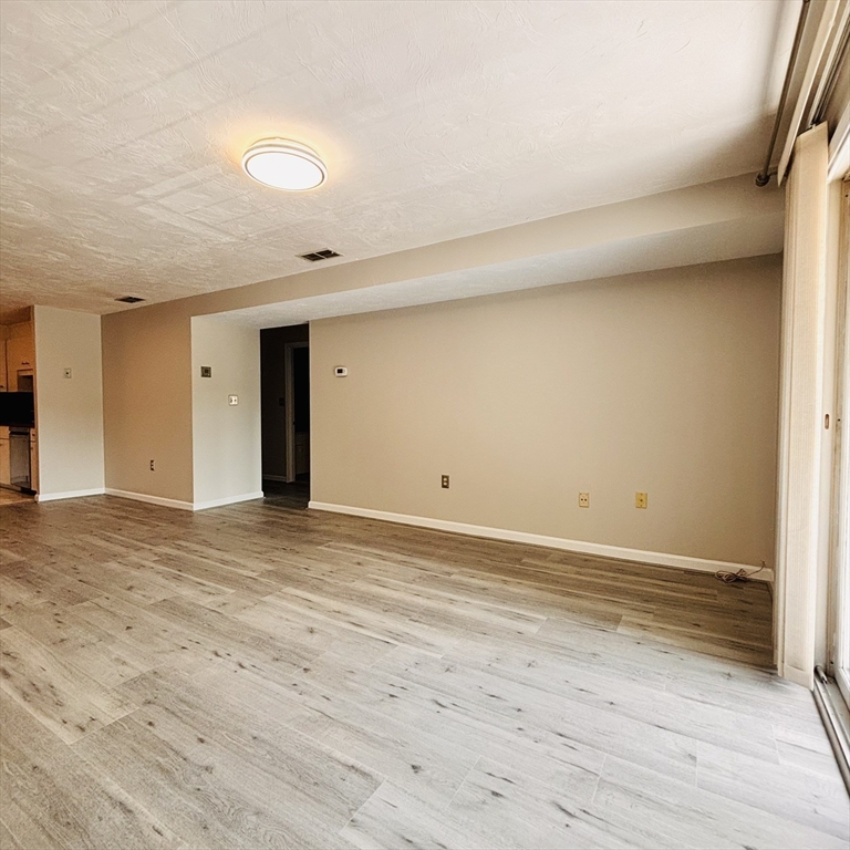 364 Neponset Street, Unit K Canton, MA 02021 - Photo 6 of 15 a view of an empty room and wooden floor