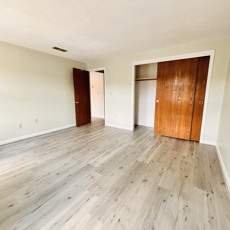 364 Neponset Street, Unit K Canton, MA 02021 - Photo 9 of 15 a view of an empty room with wooden floor
