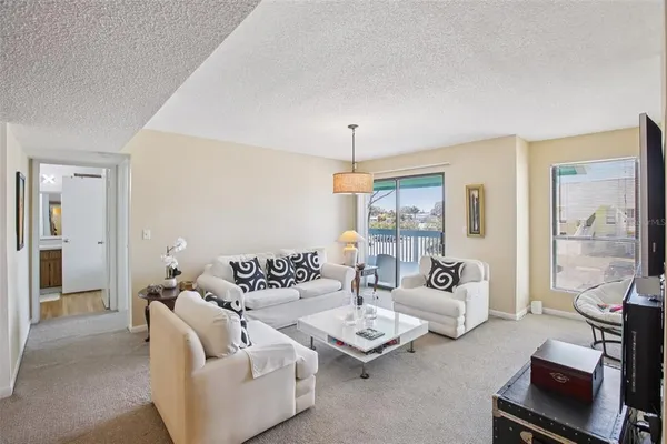 a view of a dining room with furniture and a chandelier fan