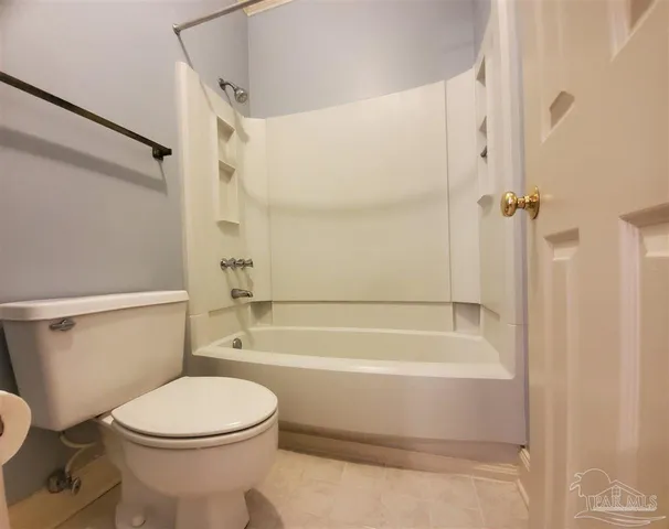 a bathroom with a toilet and a bath tub