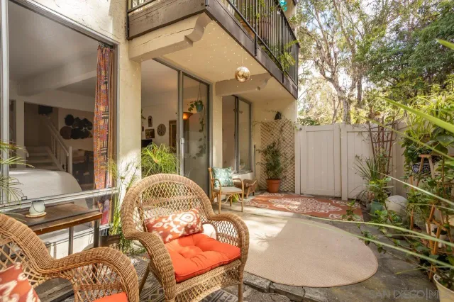 a backyard of a house with table and chairs