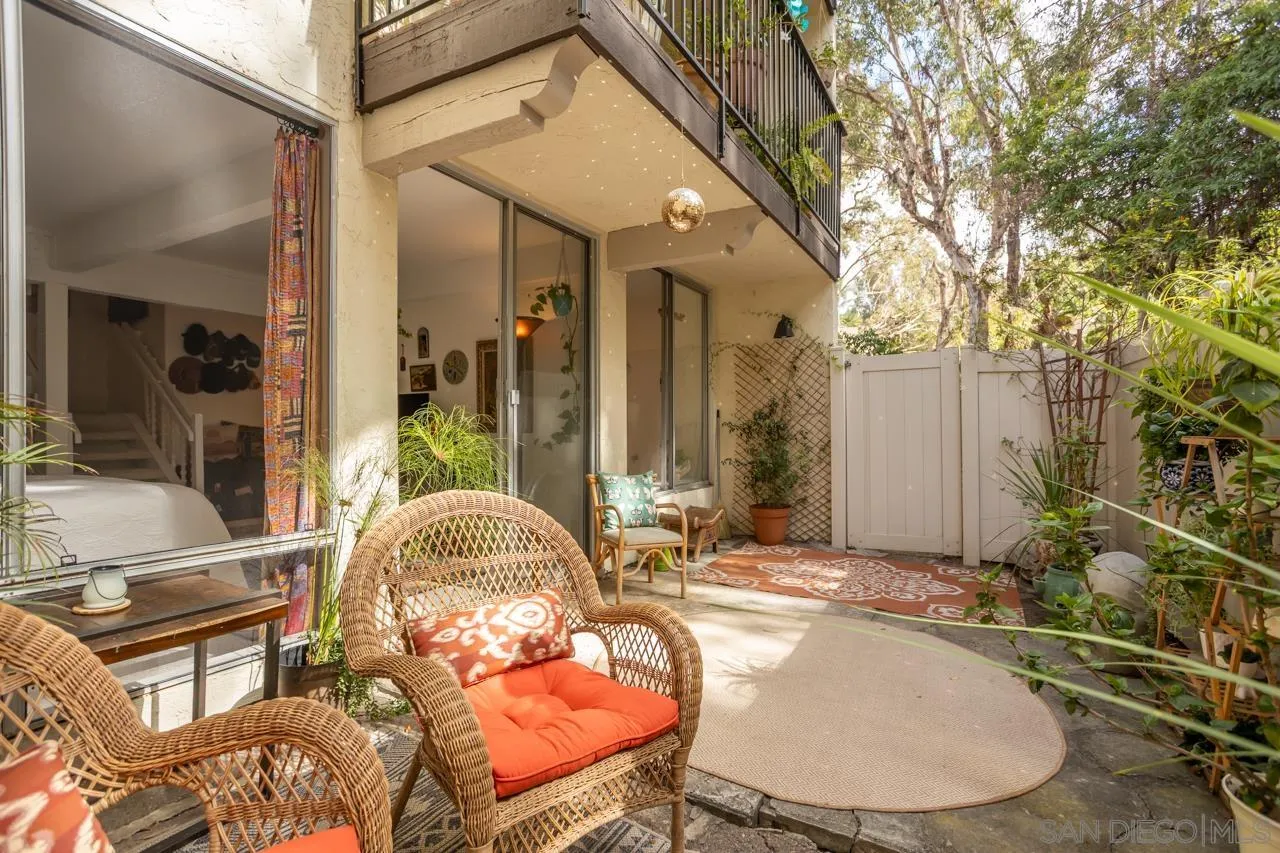 a backyard of a house with table and chairs