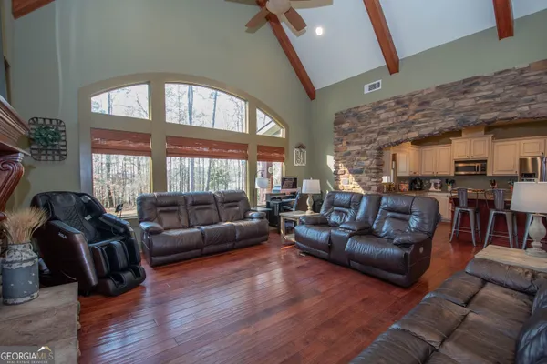 a living room with furniture and wooden floor