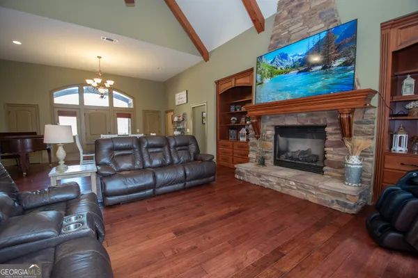 a kitchen with stainless steel appliances granite countertop a refrigerator a sink a stove a microwave and island