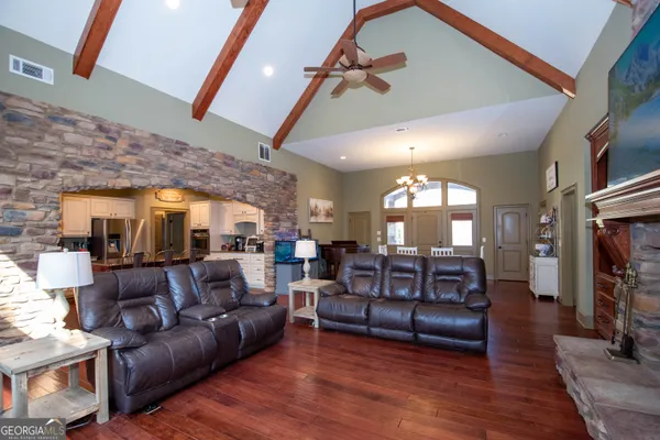 a kitchen with granite countertop kitchen island stainless steel appliances and wooden cabinets