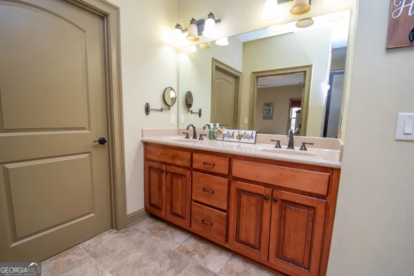 a bathroom with a toilet a sink and a window