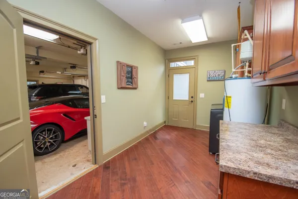 a view of a terrace with a table and chairs under an umbrella