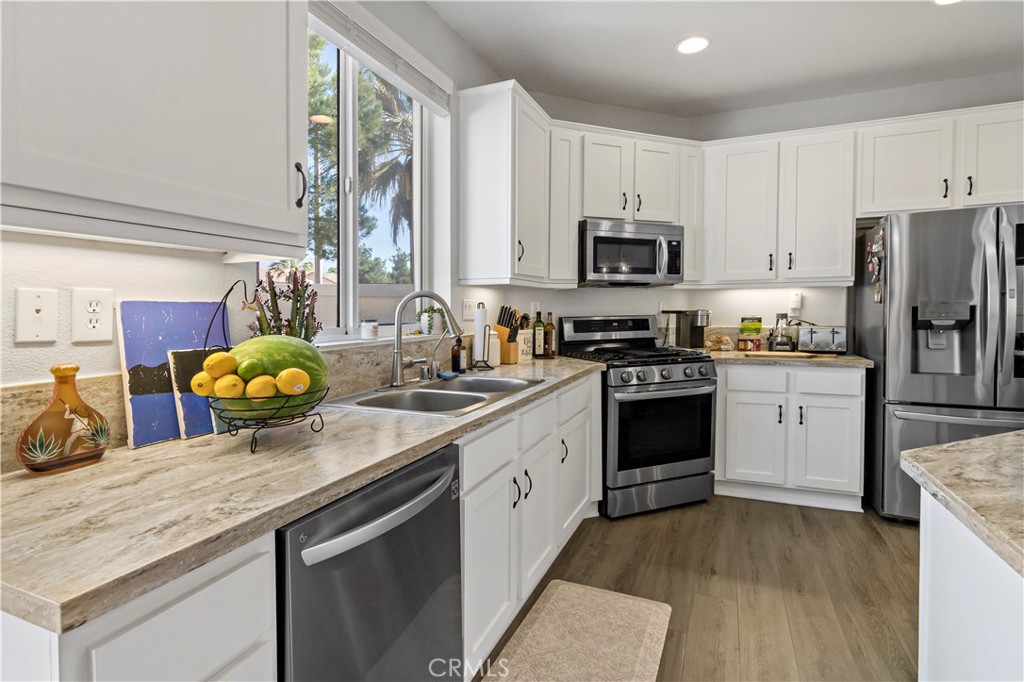 1664 Rigel Street Beaumont, CA 92223 - Photo 13 of 32 a kitchen with a sink stove and cabinets