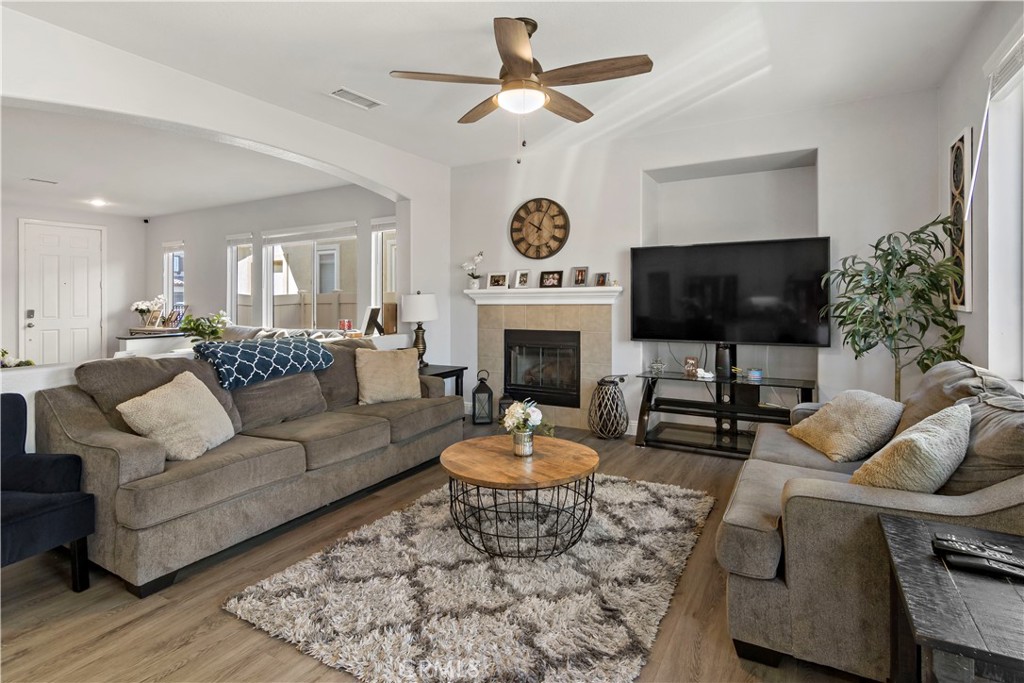 1664 Rigel Street Beaumont, CA 92223 - Photo 14 of 32 a living room with furniture a fireplace and a flat screen tv