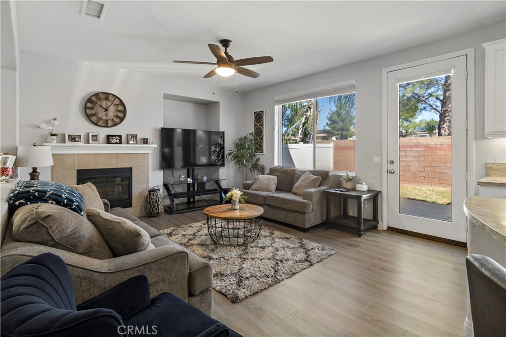 1664 Rigel Street Beaumont, CA 92223 - Photo 15 of 32 a living room with furniture a fireplace and a floor to ceiling window