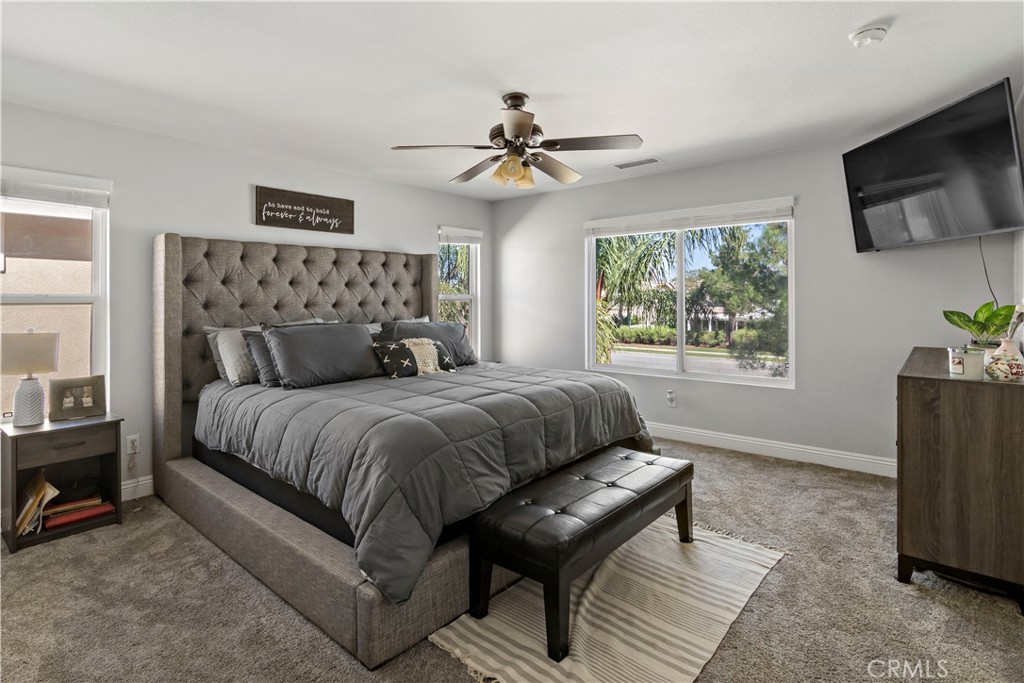 1664 Rigel Street Beaumont, CA 92223 - Photo 16 of 32 a bedroom with a bed and a chandelier