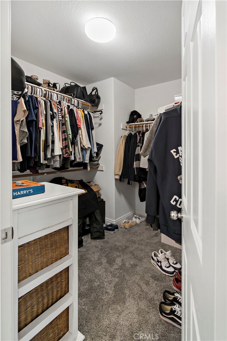 1664 Rigel Street Beaumont, CA 92223 - Photo 20 of 32 a view of walk in closet with clothes and shoes