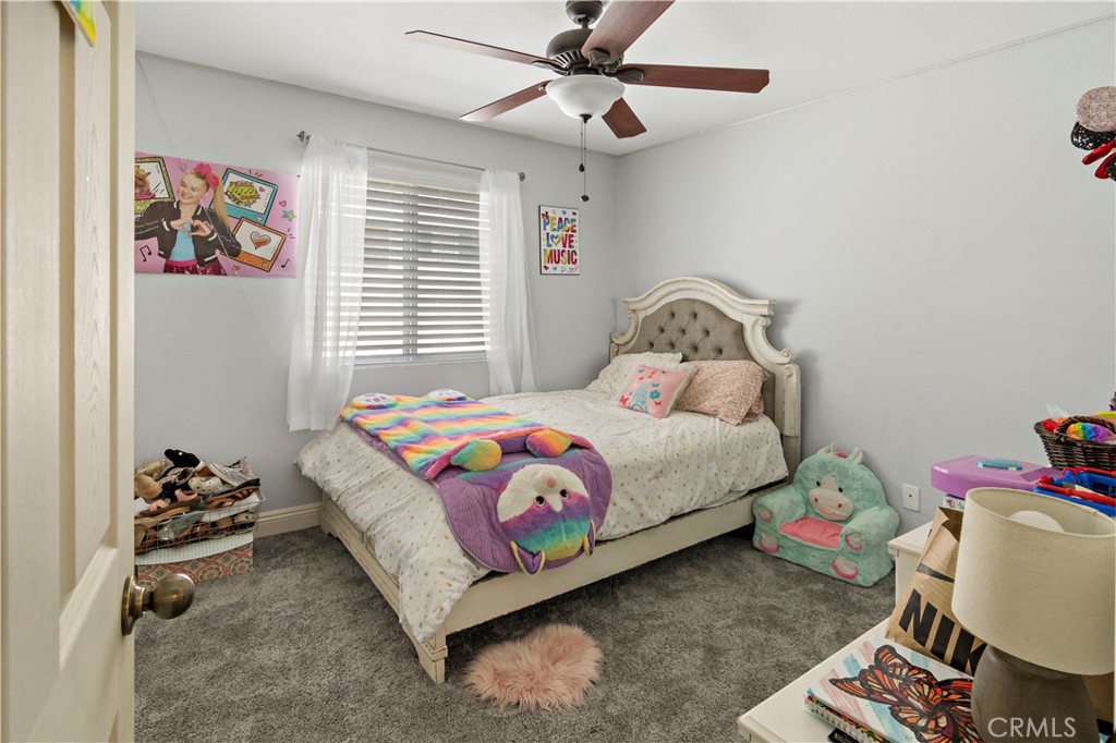 1664 Rigel Street Beaumont, CA 92223 - Photo 21 of 32 a bedroom with a bed and a window