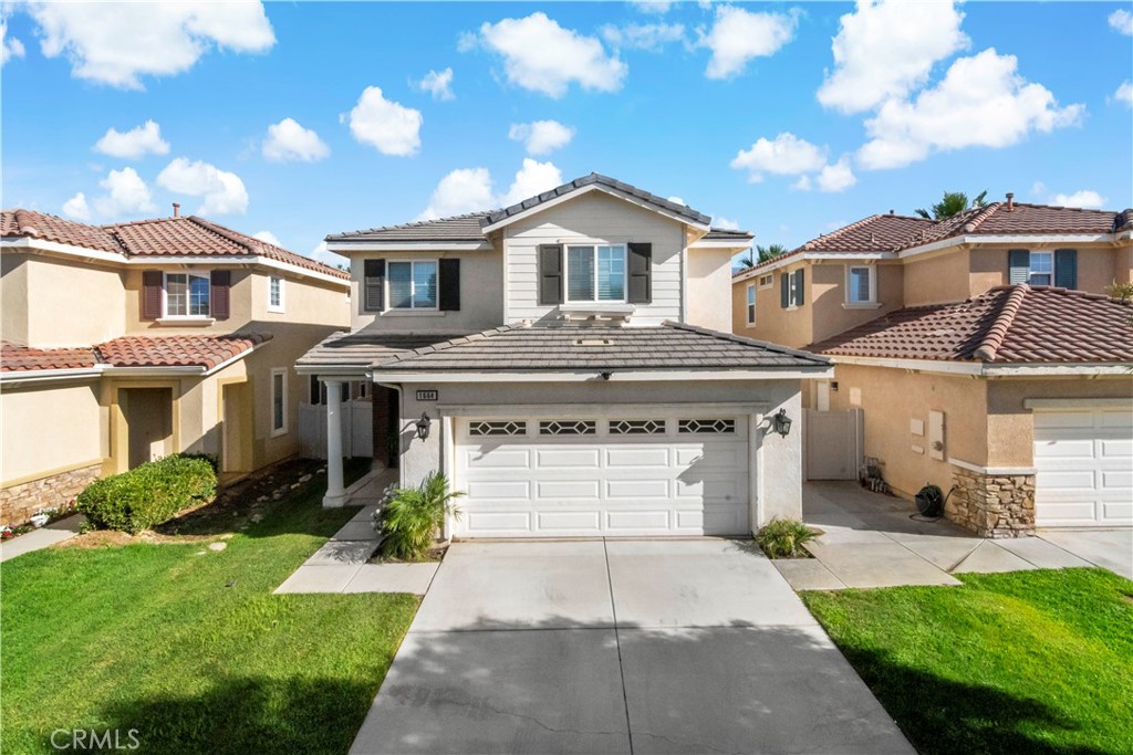 1664 Rigel Street Beaumont, CA 92223 - Photo 29 of 32 a front view of a house with a yard and potted plants