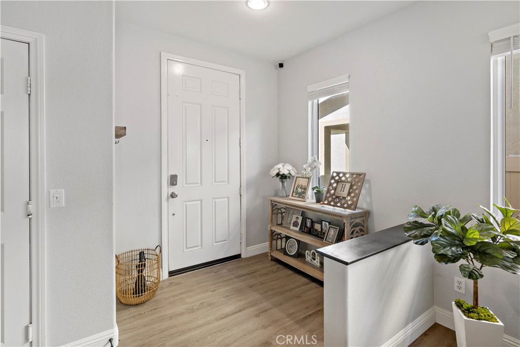 1664 Rigel Street Beaumont, CA 92223 - Photo 4 of 32 a kitchen with stainless steel appliances a white stove top oven and a wooden floor