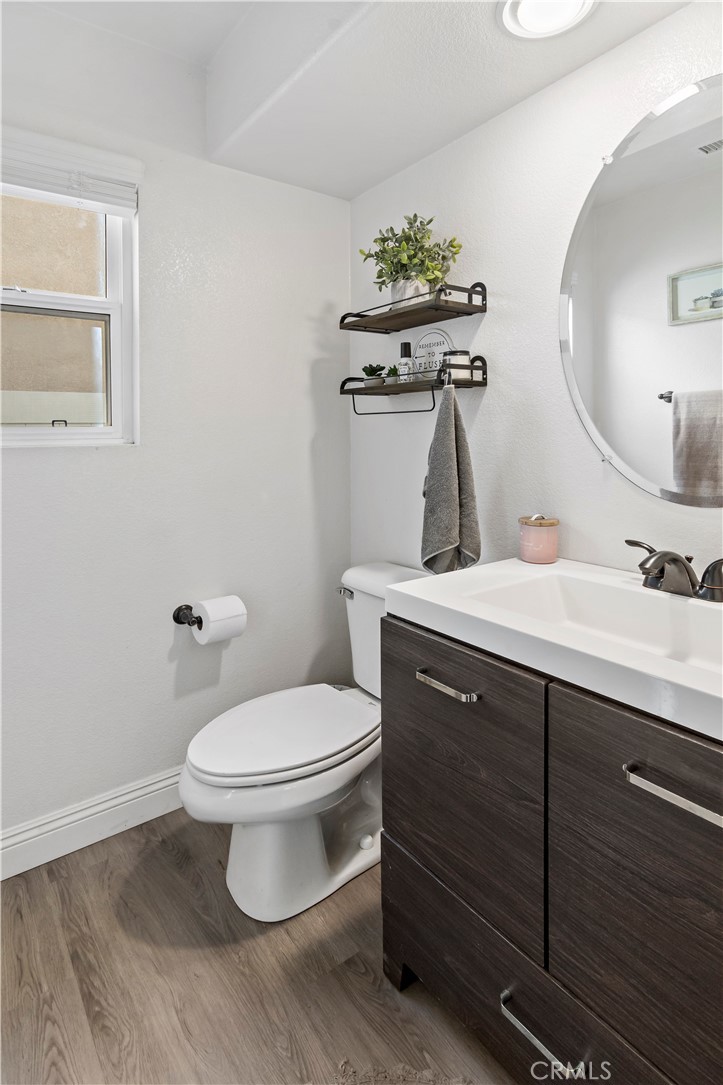 1664 Rigel Street Beaumont, CA 92223 - Photo 6 of 32 a bathroom with a toilet sink and mirror