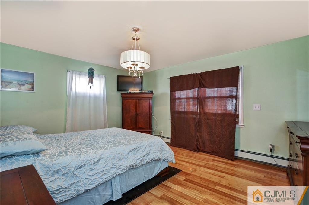 5 Baldwin Road Edison, NJ 08817 - Photo 11 of 25 a bedroom with a bed and dresser with mirror