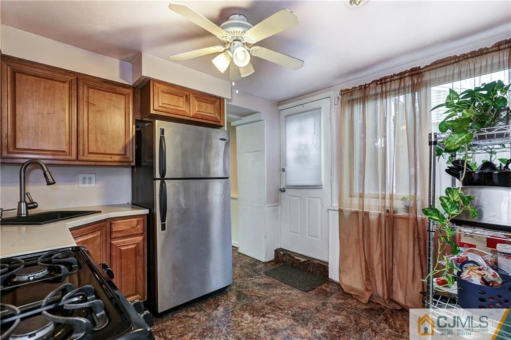 5 Baldwin Road Edison, NJ 08817 - Photo 16 of 25 a kitchen with stainless steel appliances granite countertop a refrigerator a sink and a stove top oven