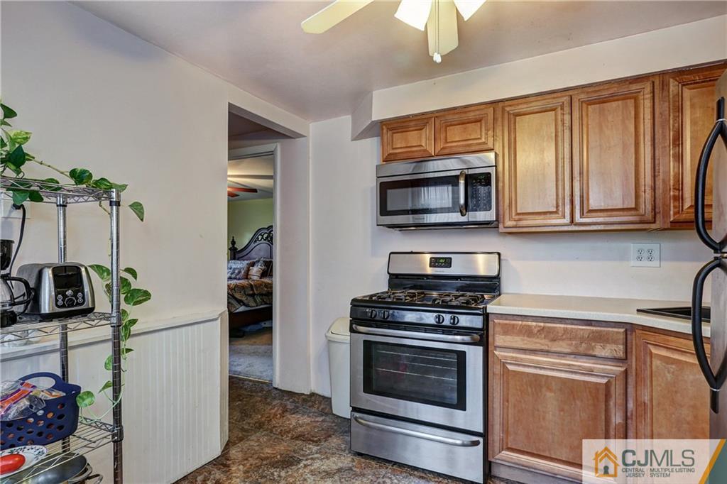 5 Baldwin Road Edison, NJ 08817 - Photo 17 of 25 a kitchen with stainless steel appliances a stove microwave and cabinets