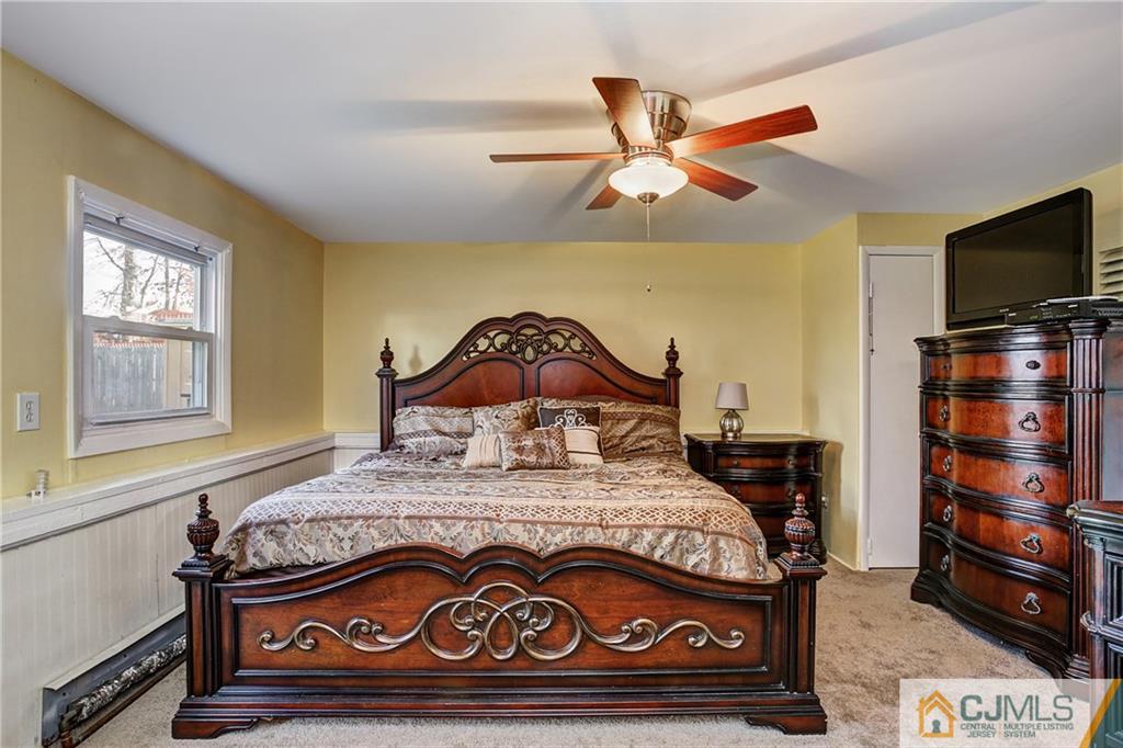 5 Baldwin Road Edison, NJ 08817 - Photo 18 of 25 a bedroom with a bed and flat screen tv