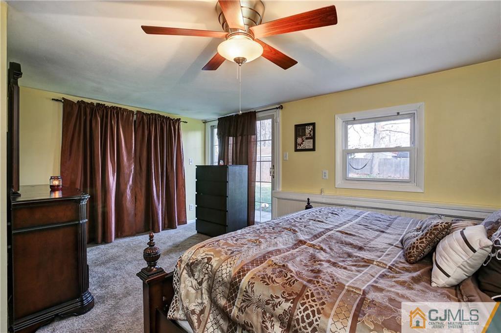 5 Baldwin Road Edison, NJ 08817 - Photo 19 of 25 a bedroom with a bed and a chandelier