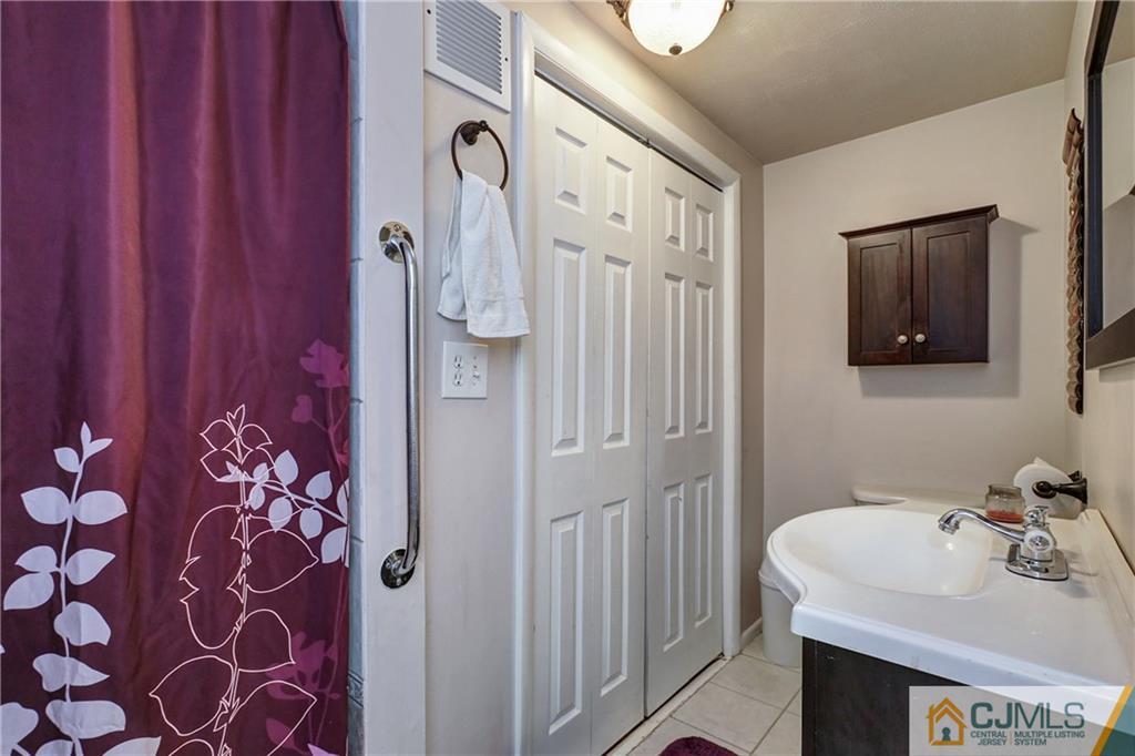 5 Baldwin Road Edison, NJ 08817 - Photo 20 of 25 a bathroom with a sink and a mirror